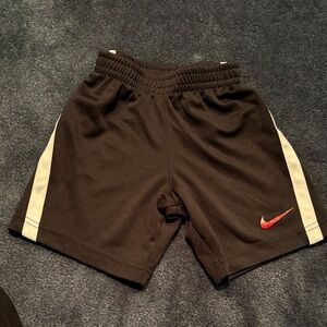 Nike Kids Black Shorts with Red Swoosh and White Side Stripes